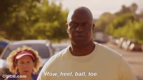 A Man Is Standing Next To A Woman And Saying Row , Heel , Ball , Toe GIF