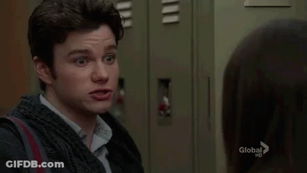 A Man Is Standing Next To A Woman In A Locker Room And Making A Funny Face . GIF