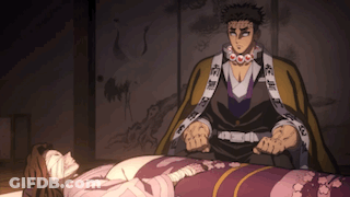 A Man Is Standing Next To A Woman Who Is Laying On A Bed . GIF