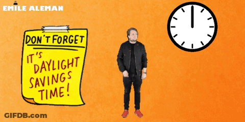 A Man Is Standing Next To A Yellow Sign That Says " Do N't Forget It 'S Daylight Savings Time " GIF