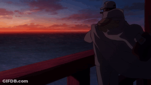 A Man Is Standing On A Balcony Overlooking The Ocean GIF