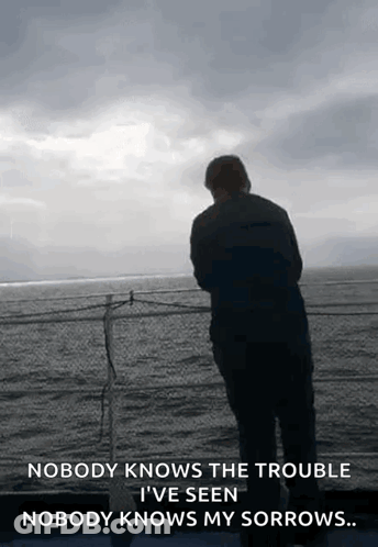 A Man Is Standing On A Balcony Overlooking The Ocean With A Quote That Says Nobody Knows The Trouble GIF