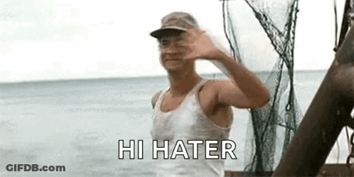A Man Is Standing On A Boat In The Ocean Waving His Hand . GIF