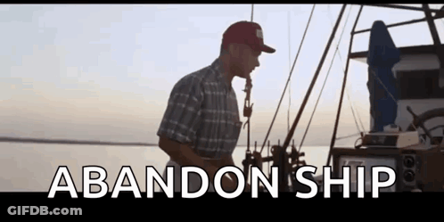 A Man Is Standing On A Boat In The Water With The Words Abandon Ship Written On The Bottom Of The Screen . GIF