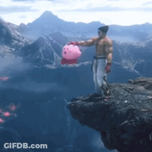 A Man Is Standing On A Cliff Holding A Pink Kirby Toy GIF
