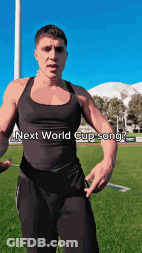 A Man Is Standing On A Field With The Words Next World Cup Song Written On His Chest GIF