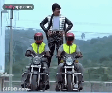 A Man Is Standing On A Motorcycle Next To Two Other Men Riding Motorcycles . GIF