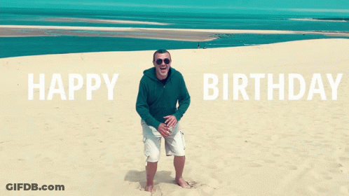 A Man Is Standing On A Sandy Beach With The Words Happy Birthday Behind Him GIF
