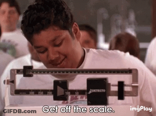 A Man Is Standing On A Scale With The Words Get Off The Scale . GIF