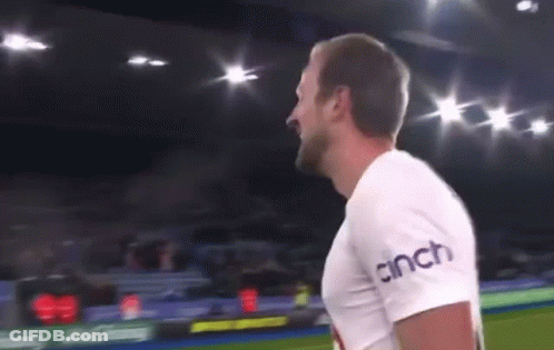 A Man Is Standing On A Soccer Field Wearing A Cinch T-Shirt . GIF