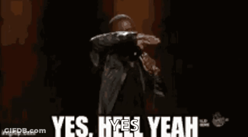 A Man Is Standing On A Stage Holding A Microphone And Saying Yes , Yes , Yeah . GIF
