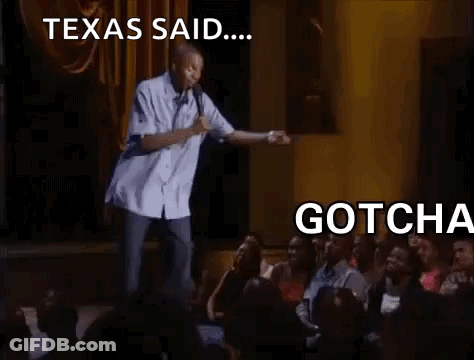 A Man Is Standing On A Stage Holding A Microphone And Talking To A Crowd . GIF