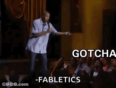 A Man Is Standing On A Stage In Front Of A Crowd Of People . GIF