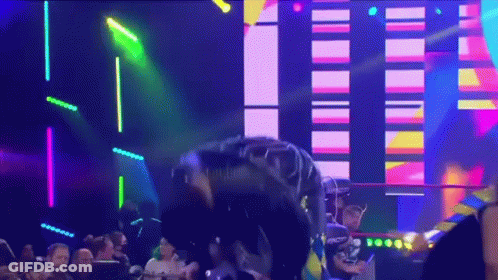 A Man Is Standing On A Stage In Front Of A Crowd With A Neon Sign That Says ' Nct ' On It GIF