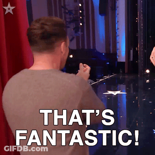 A Man Is Standing On A Stage With The Words That 'S Fantastic Behind Him GIF
