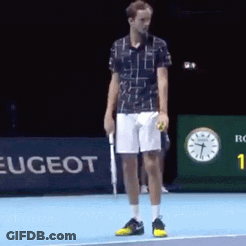 A Man Is Standing On A Tennis Court Holding A Tennis Ball And A Racket . GIF