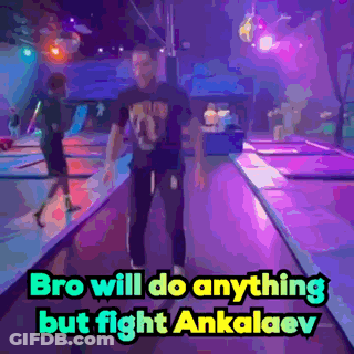 A Man Is Standing On A Trampoline With The Words Bro Will Do Anything But Fight Ankalaev Above Him GIF