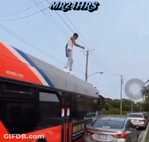 A Man Is Standing On The Roof Of A Bus With Mr24hrs Written On The Bottom GIF