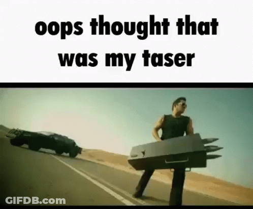 A Man Is Standing On The Side Of A Road Holding A Box That Looks Like A Car . GIF