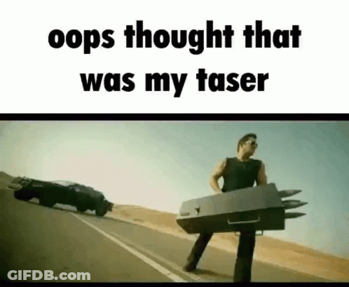 A Man Is Standing On The Side Of A Road Holding A Box With Missiles Attached To It . GIF