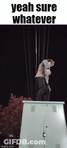 A Man Is Standing On Top Of A Utility Box With The Words Yeah Sure Whatever Above Him GIF
