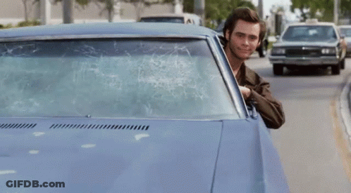 A Man Is Sticking His Finger Out Of A Car Window GIF