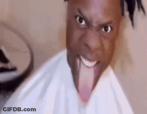 A Man Is Sticking His Tongue Out In A Funny Face . GIF