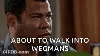 A Man Is Sweating And Looking At The Camera With The Words `` About To Walk Into Wegmans '' Written Above Him . GIF