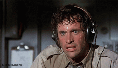 A Man Is Sweating While Wearing Headphones And Making A Face GIF