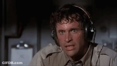 A Man Is Sweating While Wearing Headphones And Making A Funny Face . GIF