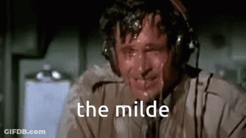 A Man Is Sweating While Wearing Headphones And The Words `` The Milde '' Are Written On The Screen . GIF
