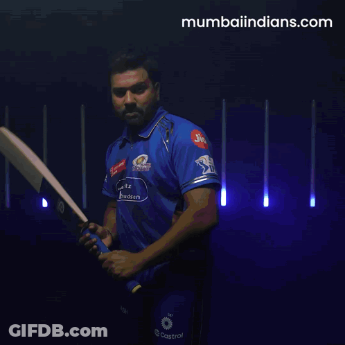 A Man Is Swinging A Bat With A Jio Logo On His Shirt GIF