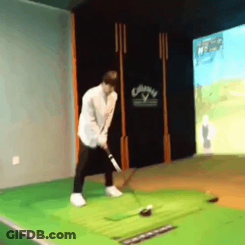 A Man Is Swinging A Golf Club In Front Of A Wall That Has The Word Callaway On It GIF