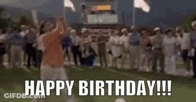 A Man Is Swinging A Golf Club On A Golf Course While A Crowd Of People Applaud . GIF