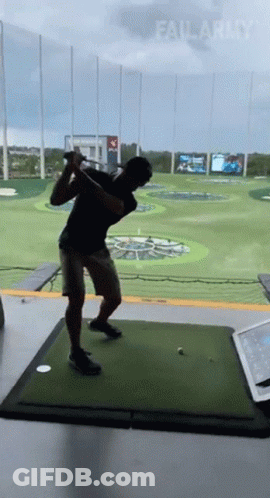 A Man Is Swinging A Golf Club On A Golf Course With Failarmy Written On The Bottom GIF
