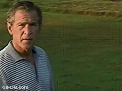 A Man Is Swinging A Golf Club On A Green GIF
