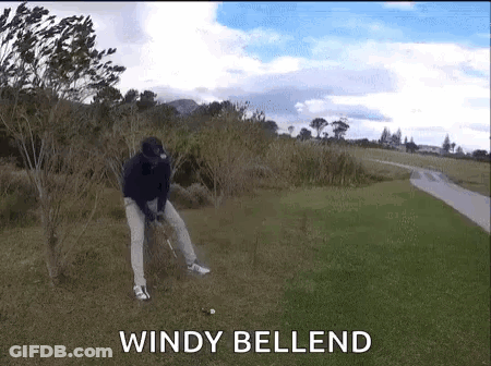 A Man Is Swinging A Golf Club On A Windy Day With The Words Windy Bellend Behind Him GIF