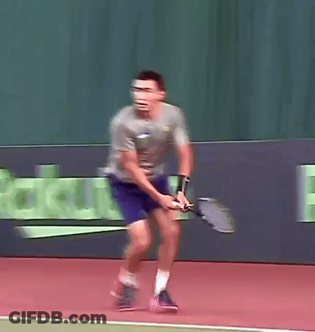 A Man Is Swinging A Tennis Racket On A Court In Front Of A Sign That Says Rakuten GIF