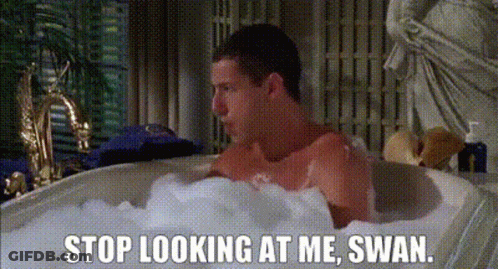 A Man Is Taking A Bath In A Bathtub Filled With Foam And Bubbles . GIF