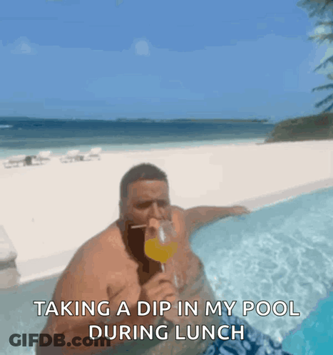 A Man Is Taking A Dip In A Swimming Pool GIF