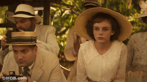 A Man Is Taking A Picture Of A Woman In A Jungle Cruise Movie GIF