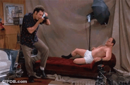 A Man Is Taking A Picture Of Another Man In Underwear GIF
