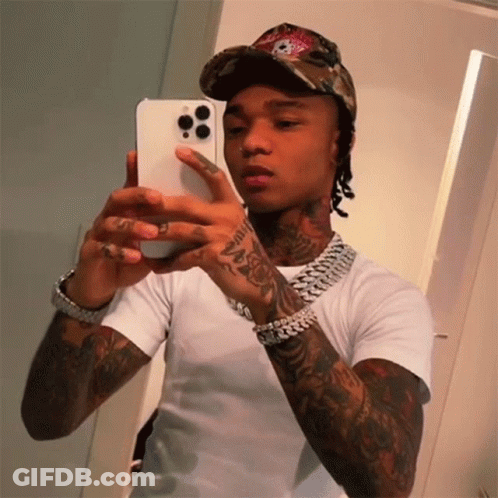 A Man Is Taking A Picture Of Himself In The Mirror GIF