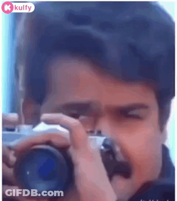 A Man Is Taking A Picture Of Himself With A Camera . GIF