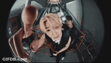 A Man Is Taking A Picture Of Himself With A Fisheye Lens While Another Man Looks On . GIF