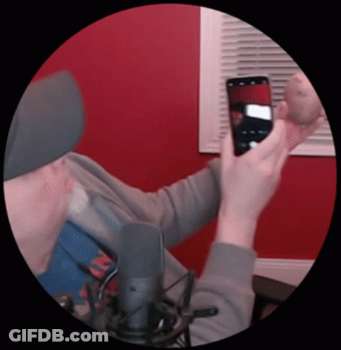 A Man Is Taking A Picture Of Himself With His Cell Phone GIF