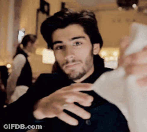 A Man Is Taking A Selfie With His Cell Phone . GIF
