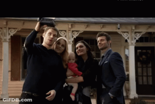 A Man Is Taking A Selfie With His Family GIF