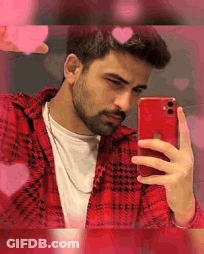 A Man Is Taking A Selfie With His Red Iphone . GIF