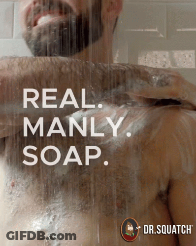 A Man Is Taking A Shower With The Words Real Manly Soap GIF